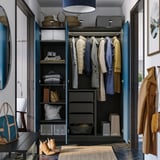 PAX wardrobe with clothes, shelves, and lighting.