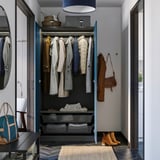 Open wardrobe displays coats, with storage shelves and drawers below.