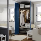 Modern blue closet with clothes, shelves, drawers, and adjustable feet.