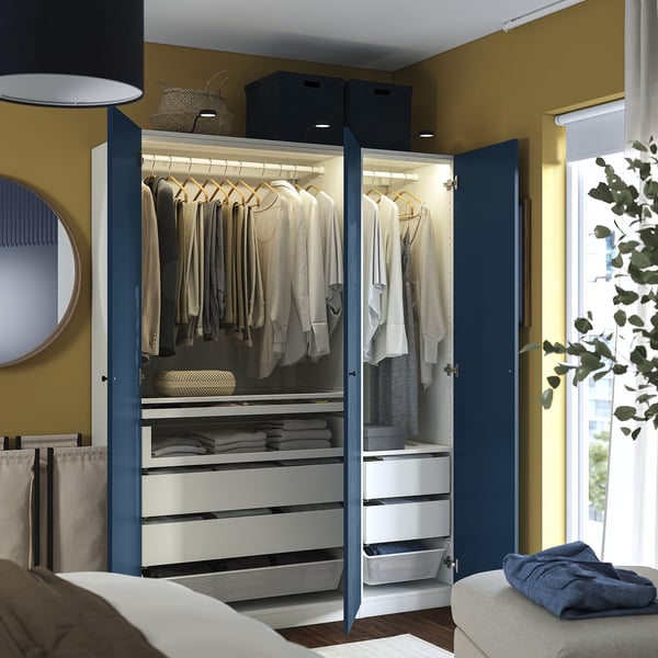 Open blue wardrobe displays lit clothes, drawers, and organizers.