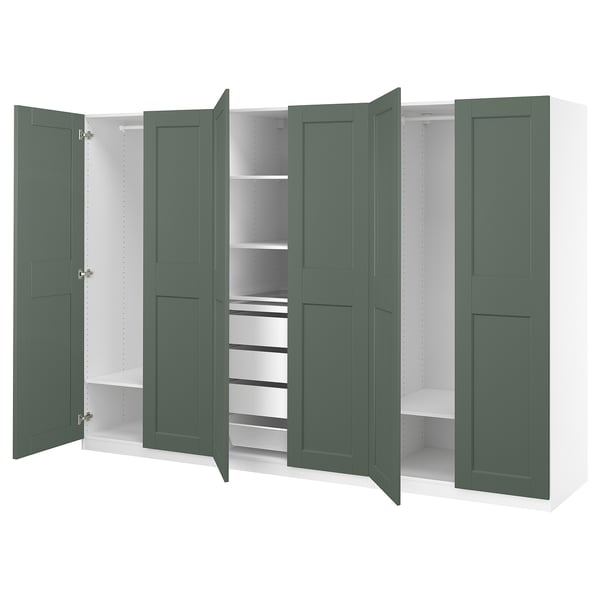Open green PAX closet with shelves and drawers, white interior, modern design.