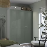 Green PAX wardrobe in room, with baskets, dress, chair, and window.