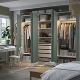 Organized bedroom closet with clothes storage, shelves, and drawers. Wardrobe doors open, revealing hanging garments, folded clothes, and accessories.
