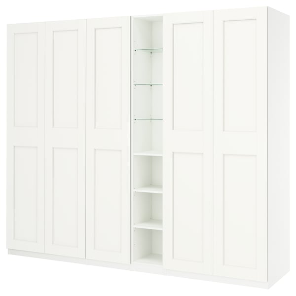 A white PAX wardrobe with closed and open sections, featuring a sleek, minimalist design.