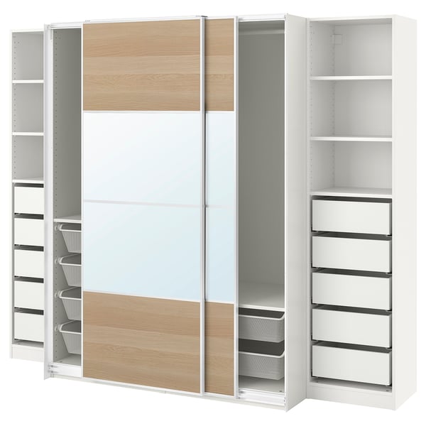 Modern white PAX wardrobe with sliding mirrored doors, wooden panel accents, and multiple storage compartments including shelves and drawers.
