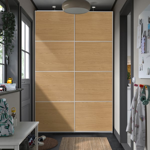 PAX wardrobe: tall, light wooden closet with sliding doors, flanked by smaller furniture.