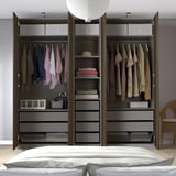 PAX wardrobe with hanging clothes, shelves, and storage boxes for organized space.