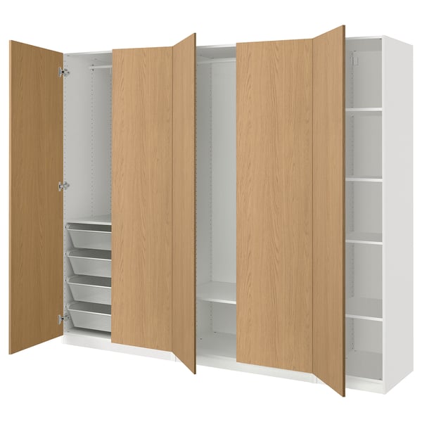 An open oak-colored ikea PAX wardrobe with shelves and drawers.