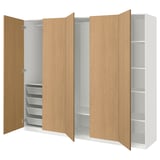 An open oak-colored ikea PAX wardrobe with shelves and drawers.