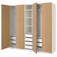 An open light wood PAX wardrobe featuring shelves and drawers.