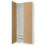 An open white and light wood-colored PAX wardrobe with shelves and drawers.