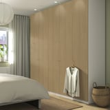 Bedroom with PAX wardrobe, bed, and shirt on door.