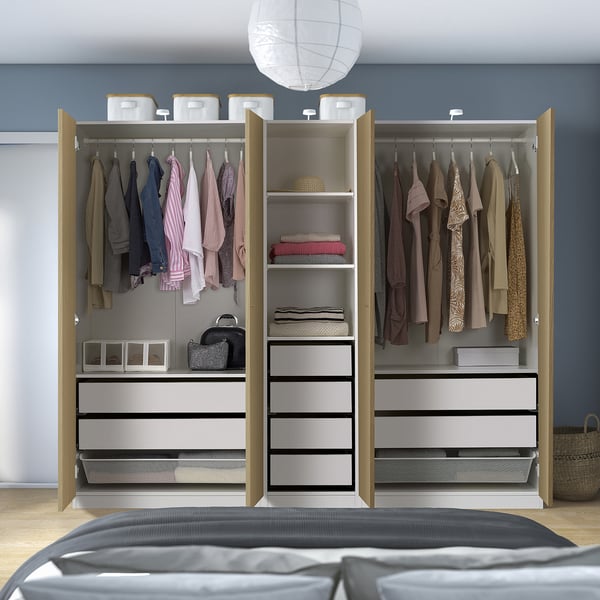 An open wardrobe showcasing clothes, folded items, and accessories in organized drawers and shelves, with adjustable storage solutions.