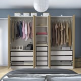 An open wardrobe showcasing clothes, folded items, and accessories in organized drawers and shelves, with adjustable storage solutions.