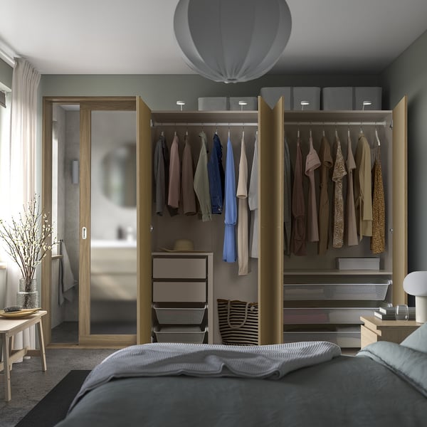 Modern wardrobe with open doors showing clothes and adjustable storage.