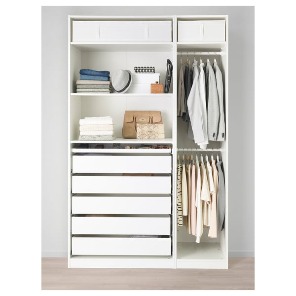 White wardrobe with drawers, shelves, and hanging space for clothes. Organized with folded clothes, handbags, and boxes.