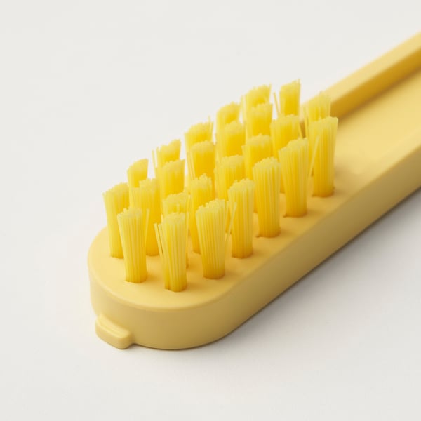 Yellow PEPPRIG shoe brush with dense bristles on a plain background.