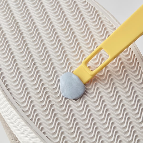 Small shoe brush with scraper for cleaning shoe edges.