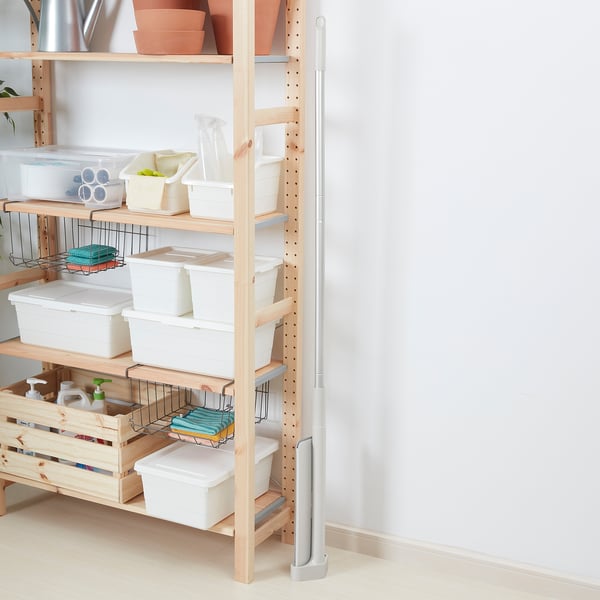 Shelf with storage bins and containers, some with visible contents, organized for easy access.
