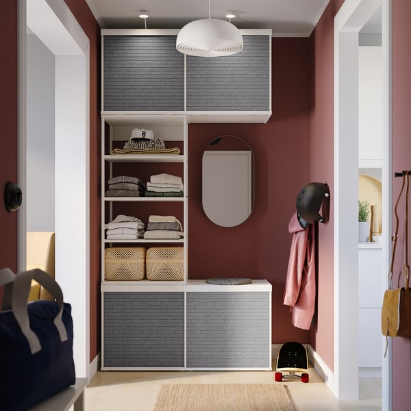 Organized closet with gray PLATSA shelves, hanging jacket, skateboard, and helmet. Modern design with sliding doors.