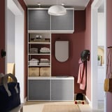 Organized closet with gray PLATSA shelves, hanging jacket, skateboard, and helmet. Modern design with sliding doors.