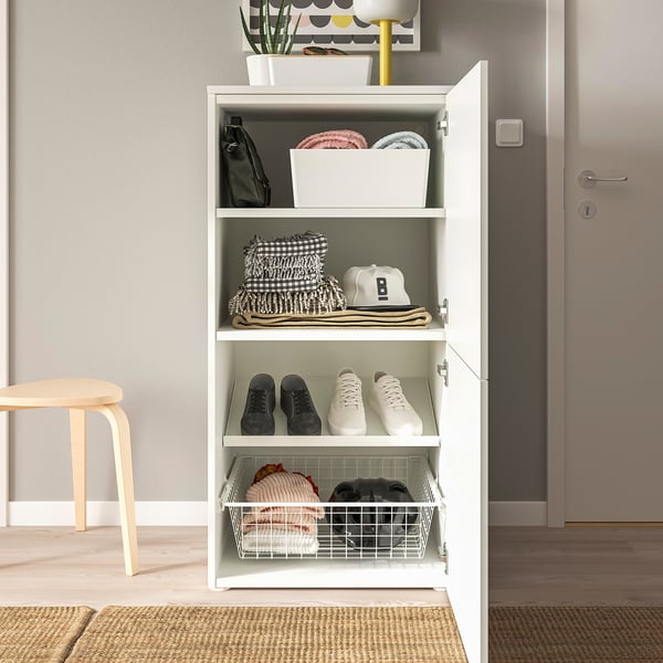 Open white PLATSA storage unit displaying shoes, folded clothes, and accessories on shelves, with additional storage baskets.