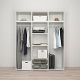 A white PLATSA wardrobe stores clothes, folded piles, and accessories in shelves, hanging rails, and storage boxes.