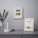 Wooden frames: beach & blurred images among home decor.