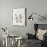 Living area with gray PLOMMONTRÄD frame, flowers, and stylish lamp.