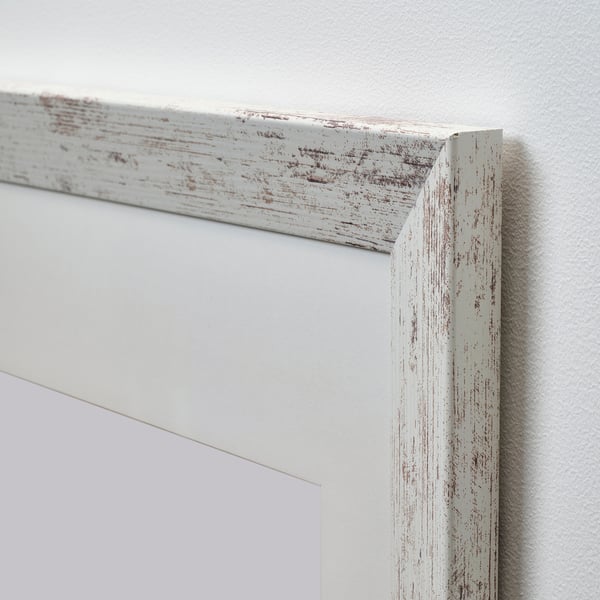 Whitewashed wooden picture frame with distressed texture. Close-up shows solid craftsmanship and detailed edge.