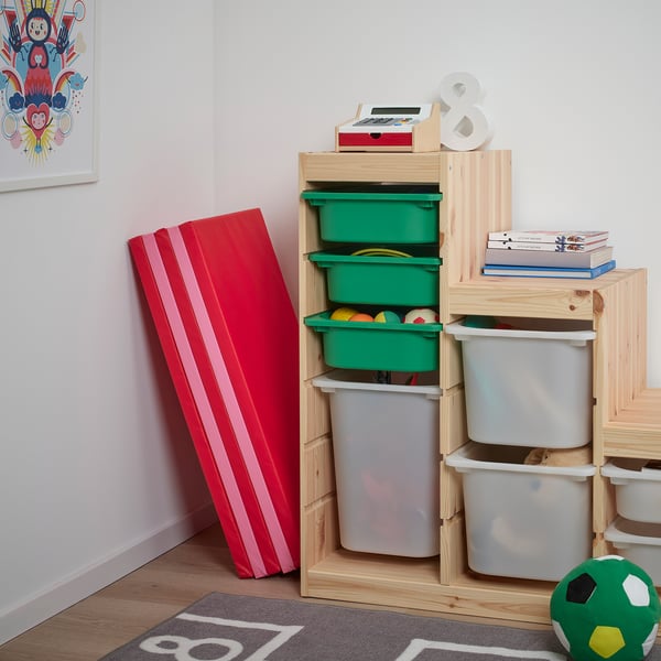Kids playroom with wooden storage, colorful bins, and PLUFSIG foldable red mat for somersaults.
