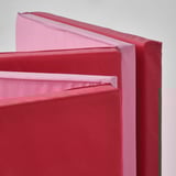 Stacked red and pink soft gym mats, ideal for kids play and safety.