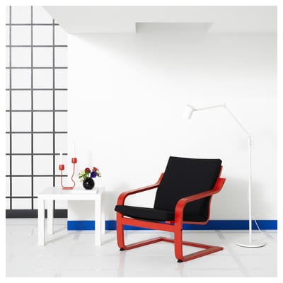 Red POÄNG armchair with black cushion, minimalist design.