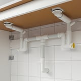 Plumbing setup with adjustable RÄNNILEN water traps for sink, washer, or dryer connections.