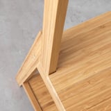 Each piece of light-colored bamboo on this chair neatly fits, showing its sturdy construction and natural beauty.