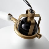 Modern golden lamp with black shade, adjustable joints, striped cable, sleek design.