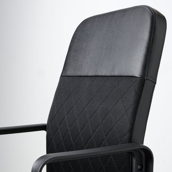 Close-up of ergonomic office chair, showcasing comfortable fabric backrest and sturdy armrest.