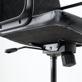 Close-up of a modern office chairs base and armrest. Shows high-quality materials and engineering.