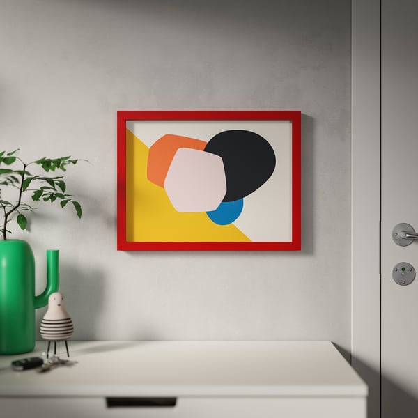 Modern art print with red frame, abstract colors, green plant, white door.