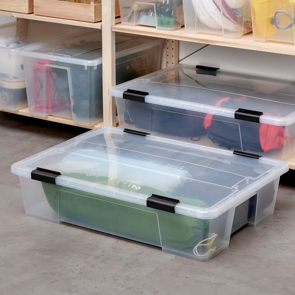 SAMLA clear storage bins with black clip locks. Various sizes fit together neatly, ideal for organizing items.