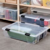 SAMLA clear storage bins with black clip locks. Various sizes fit together neatly, ideal for organizing items.