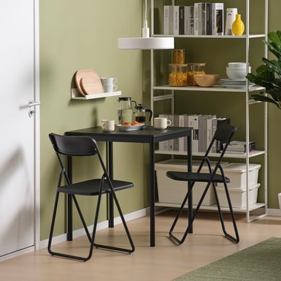 Small black sandberg table and chairs, green room.