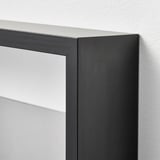 Black picture frame with clear plastic cover, good quality, on a white wall.