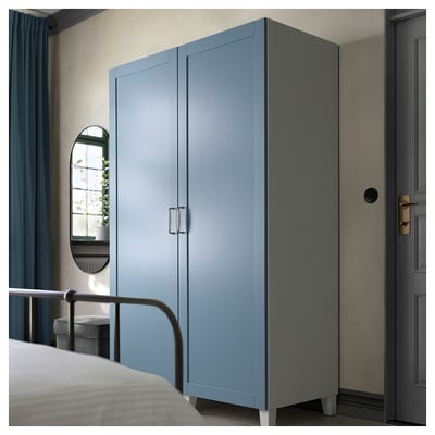 Blue SANNIDAL wardrobe, modern rectangular design, with smooth foil finish, in a serene bedroom setting.