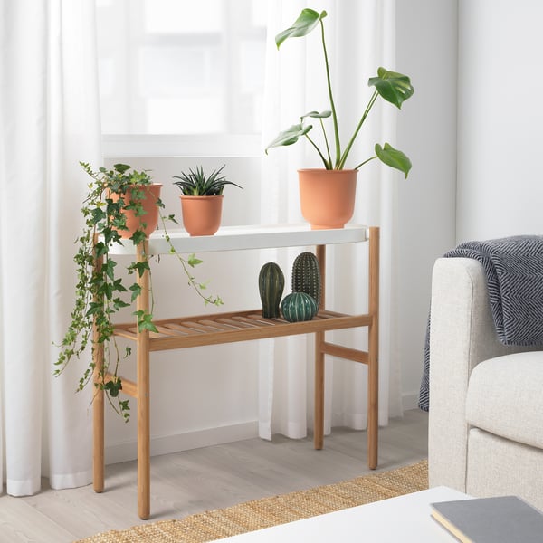 SATSUMAS plant stand with 3 potted plants. Natural wood, fits room with white couch & curtains.