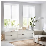 Modern living room with white furniture, plants, and SCHOTTIS light-diffusing blinds on windows.