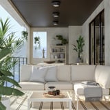 Modern outdoor living area with white SEGERÖN sofa, coffee table, and greenery.