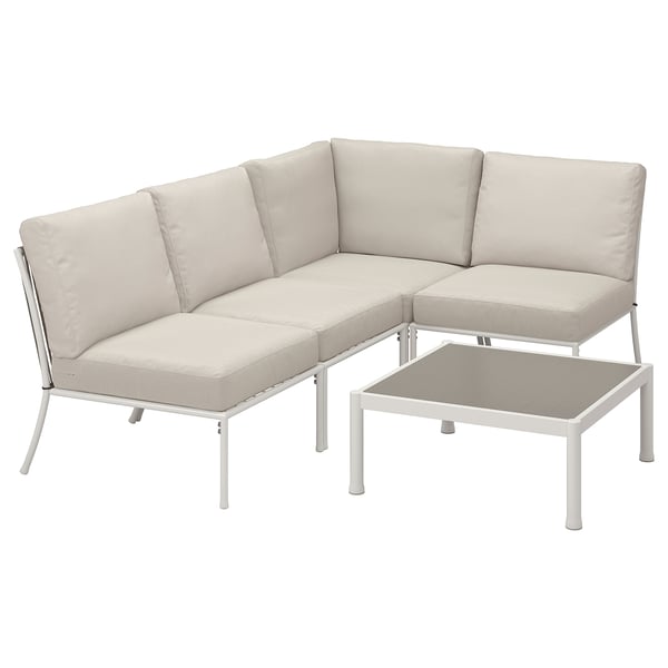 A modern outdoor corner sofa set, white metal frame with beige cushions and a matching coffee table.