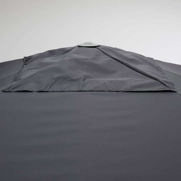 Gray fabric umbrella with sun protection, tilted to block rays.