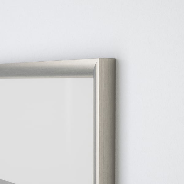 Close-up of metallic silver picture frame corner, sleek and modern.